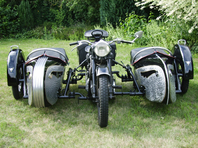 A motorcycle with two sidecars and zero safety